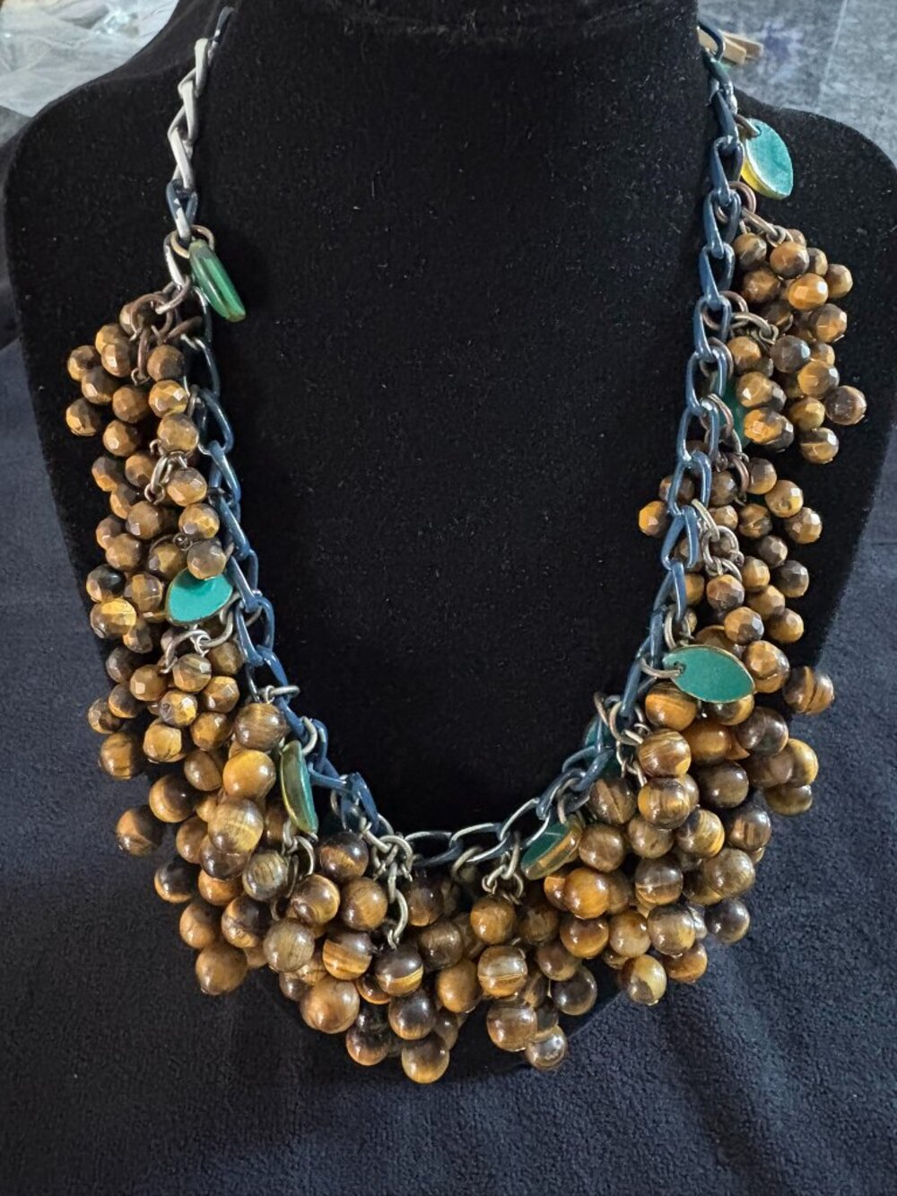 Heavy beaded necklace with brown beads and green accent stones